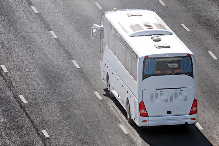 aerial view of white bus driving on street